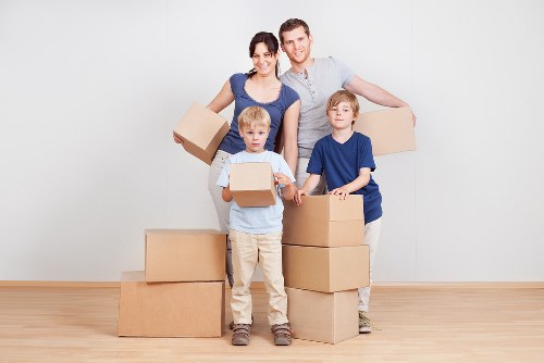 Organized storage unit in Beckton with packed boxes and furniture